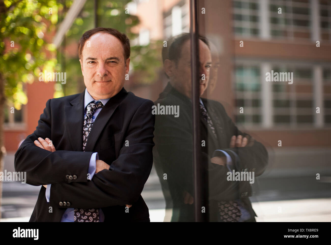 Man in suit stands arms hi-res stock photography and images - Alamy