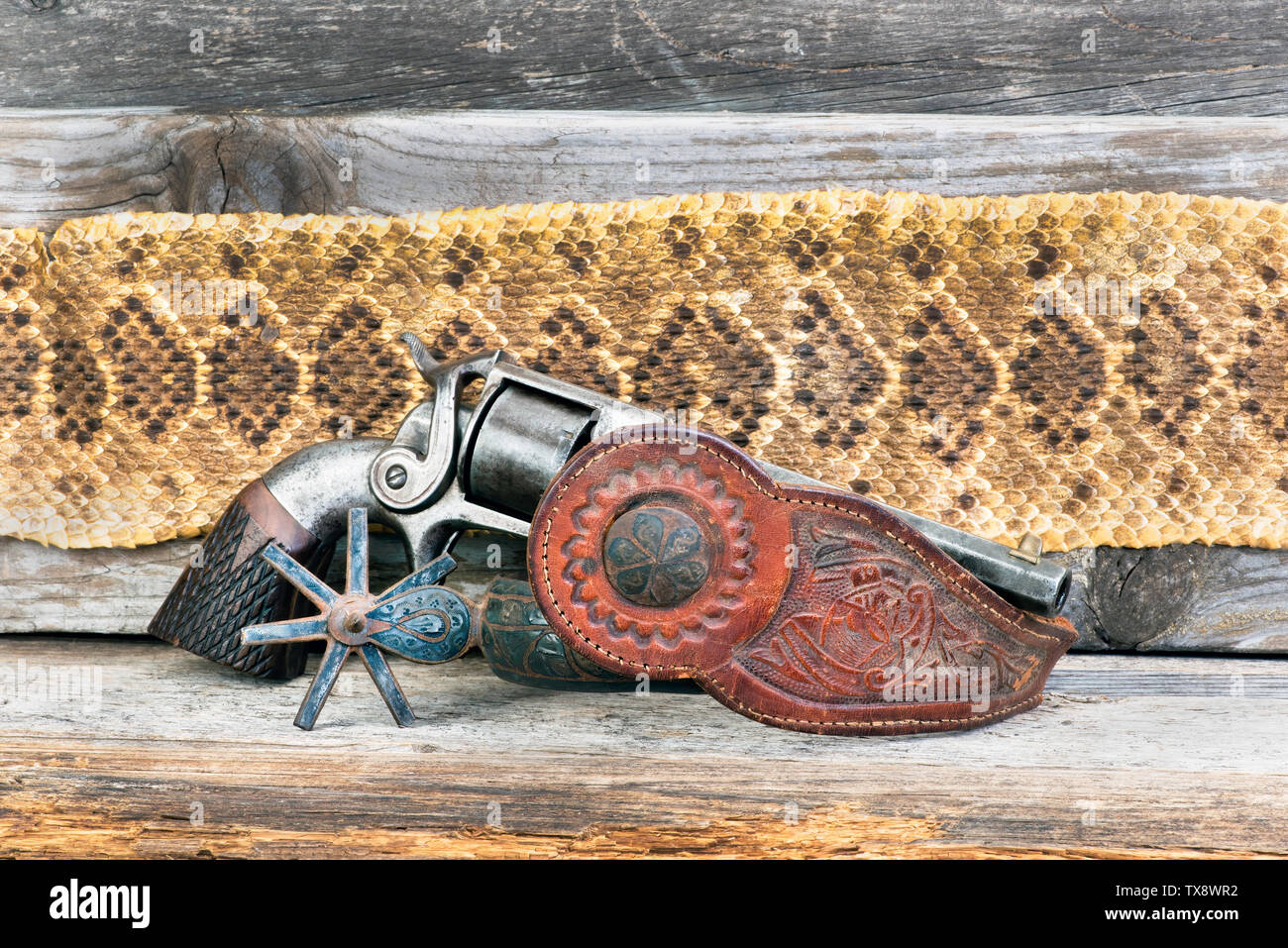 Antique side hammer pistol with Mexican spur and Texas Rattlesnake skin. Stock Photo