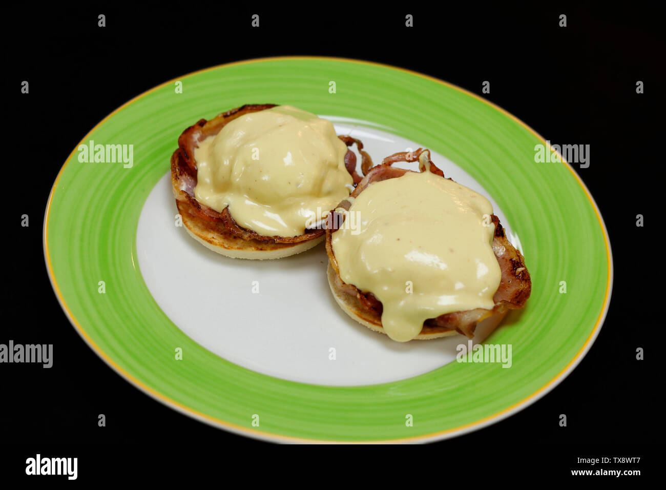 egg Benedict with poach egg, bacon and spinach Stock Photo