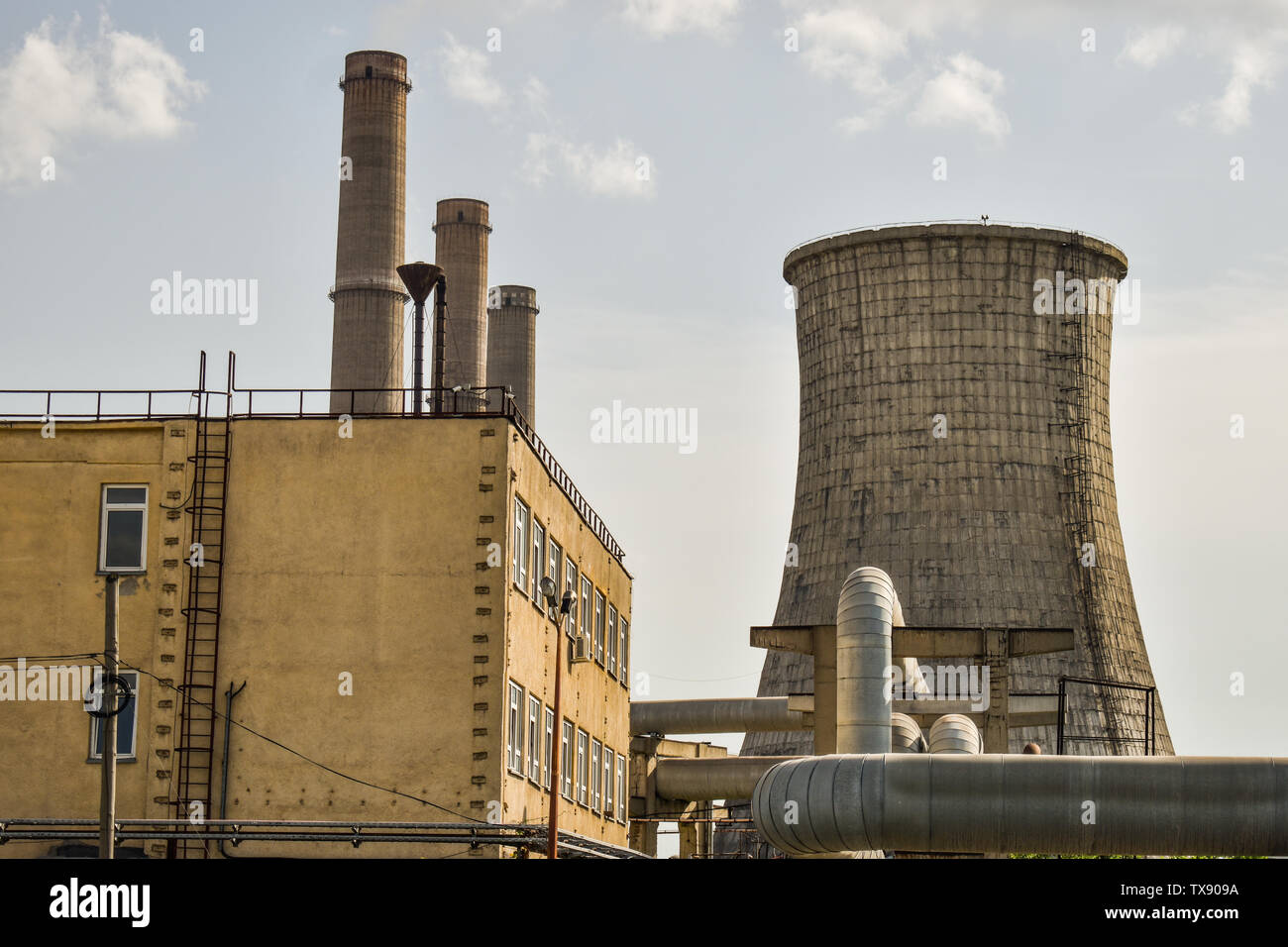View of old power plant with big concrete furnaces . Fallen chemical communist industry. Stock Photo
