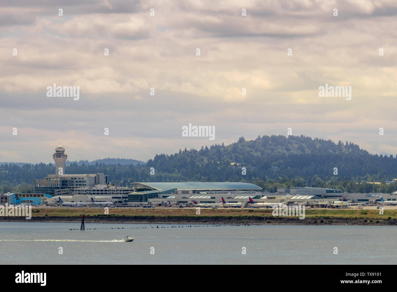 Portland, OR / USA - June 2019: View of concourse D and E with Air Traffic Control (ATC) tower at Portland International Airport (PDX) Stock Photo