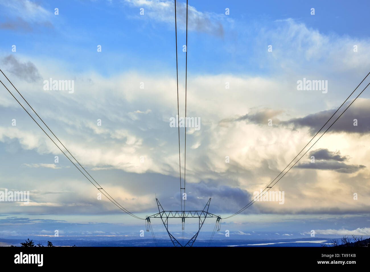 Electric tower in blue sky with clouds at sunset Stock Photo - Alamy