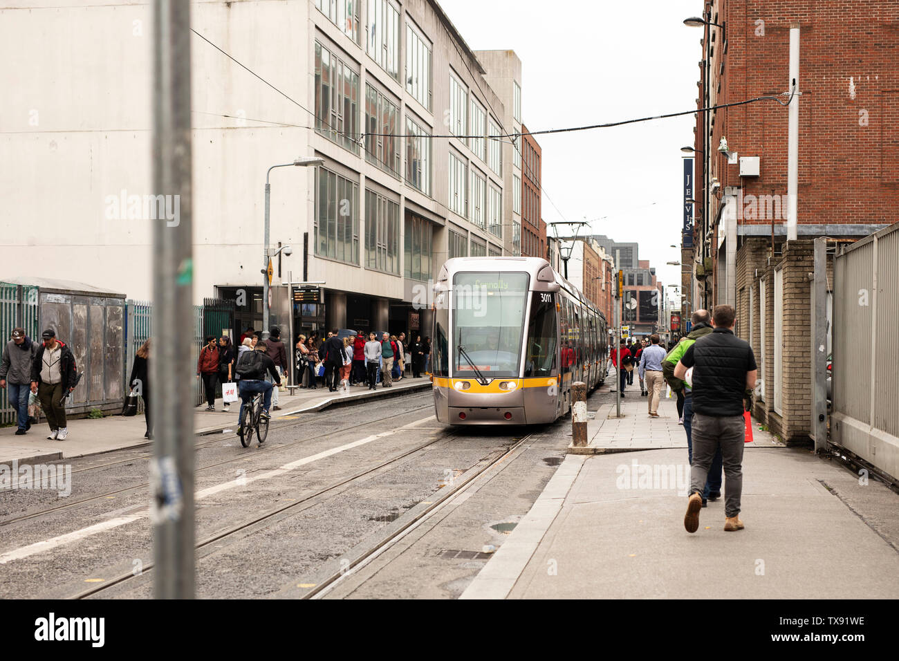 A tram travels down Abbey Street Upper in Dublin, Ireland. Stock Photo