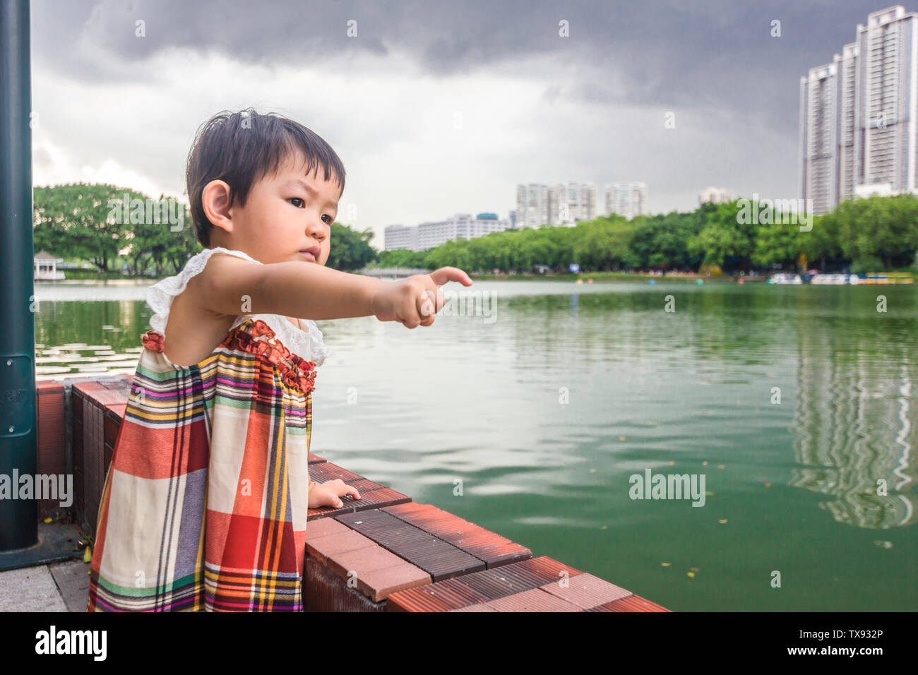 Little girl by the lake Stock Photo - Alamy