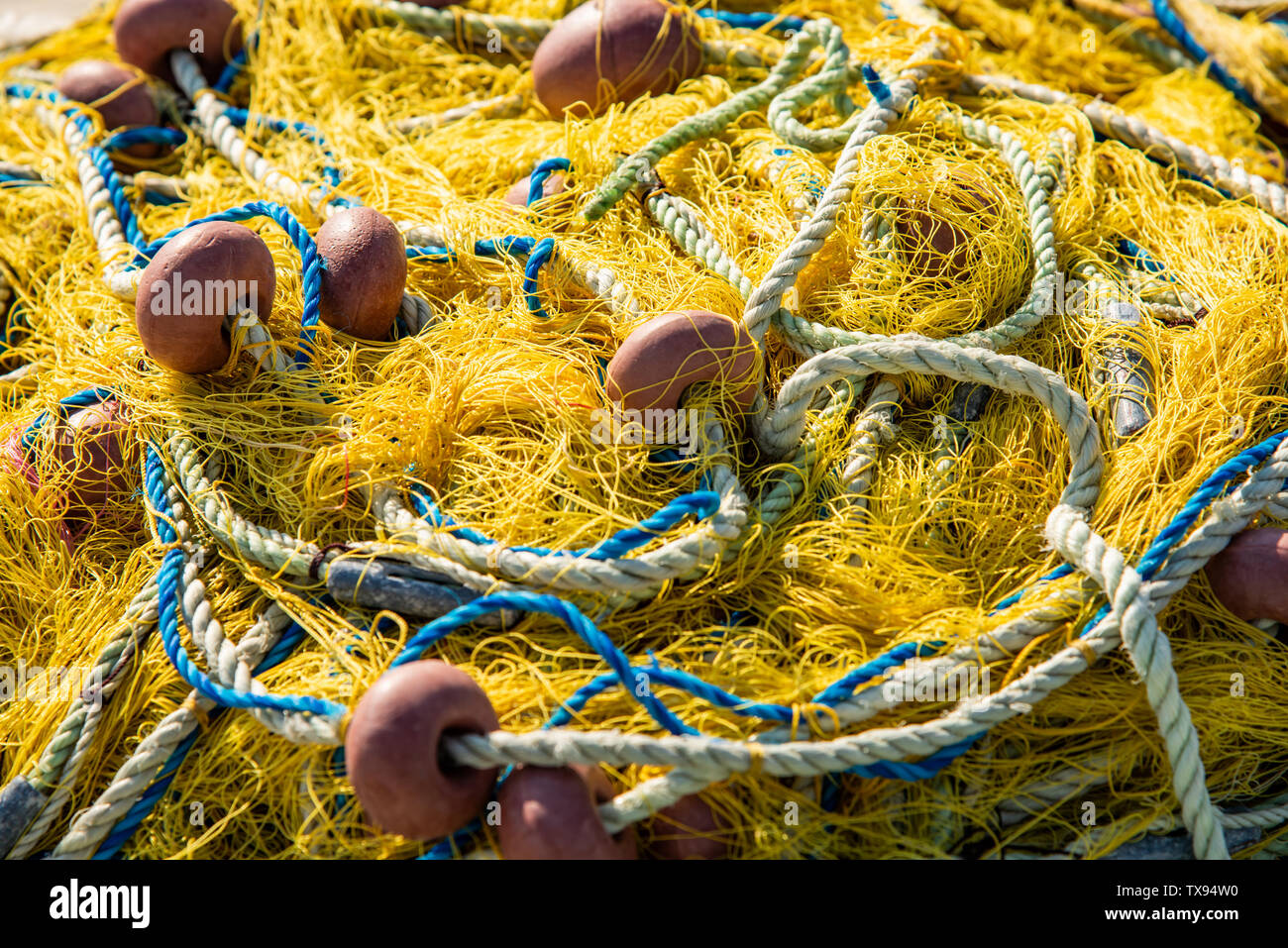 heap of fishing nets  with rope and floatings Stock Photo