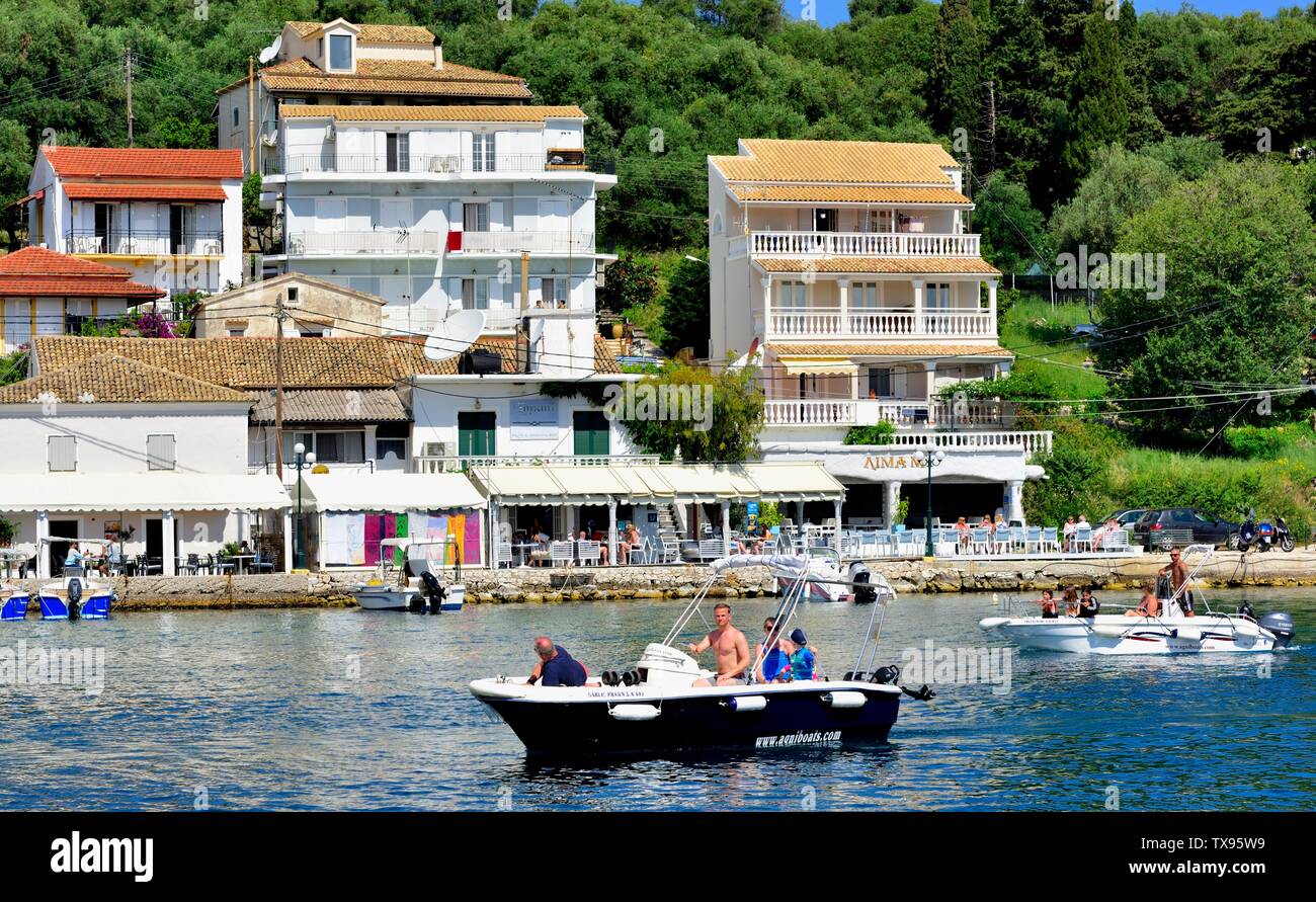 Tourists arriving at Kassiopi bay in a hire boat,Kassopaia,Ionian Islands, Corfu ,Greece Stock Photo