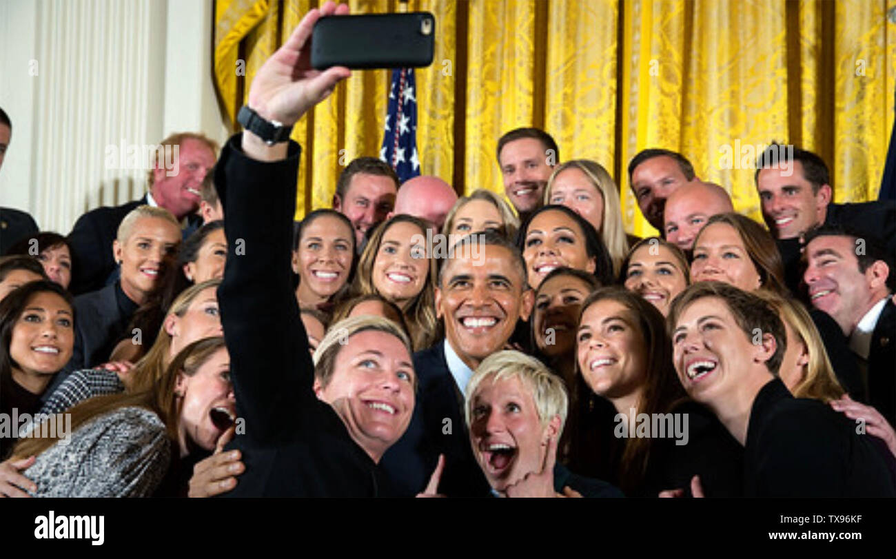 BARACK OBAMA as 44th President of the United States about 2012 with White House staff. Photo: White House. Stock Photo