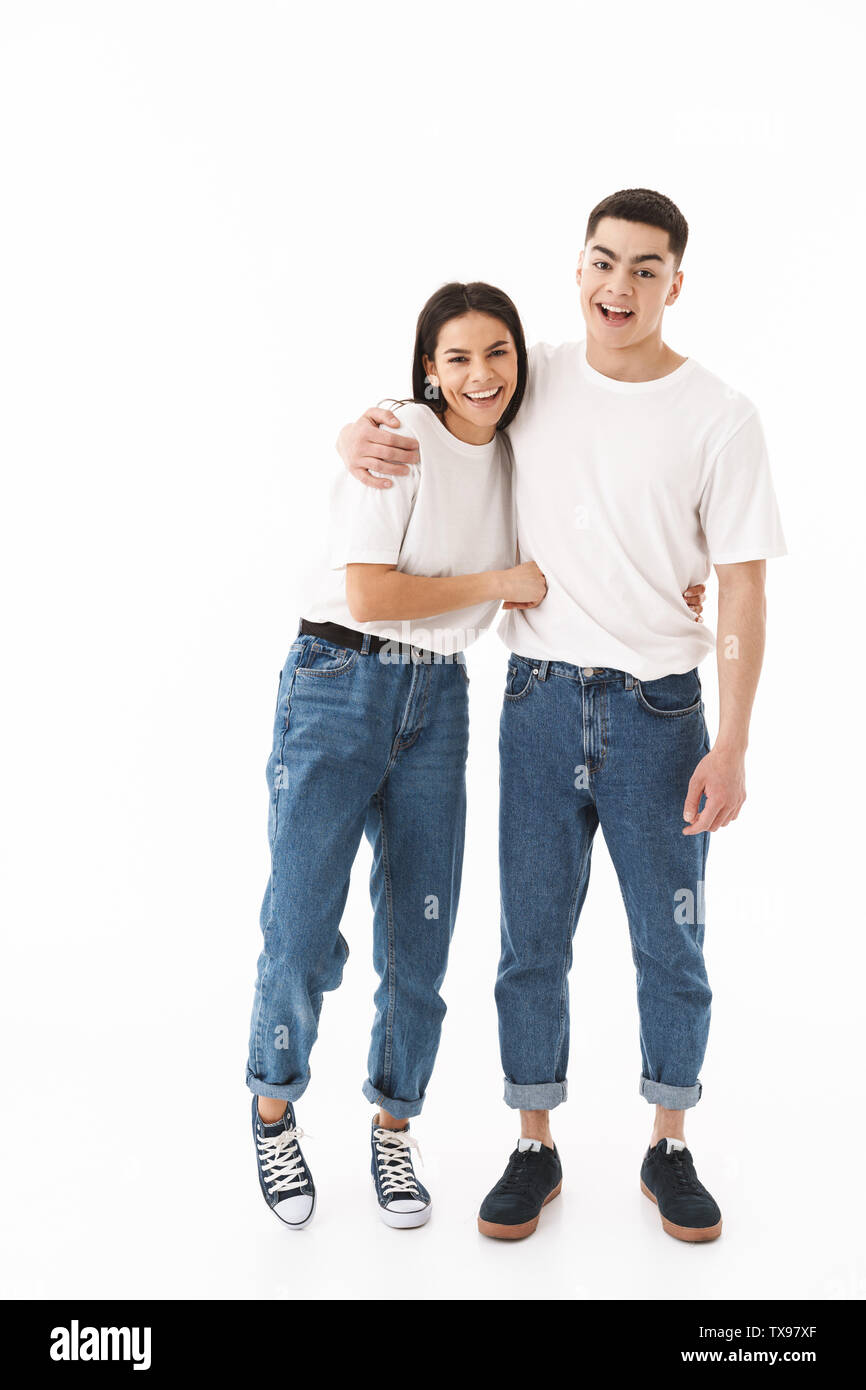 Full length portrait of a young attractive couple standing isolated ...
