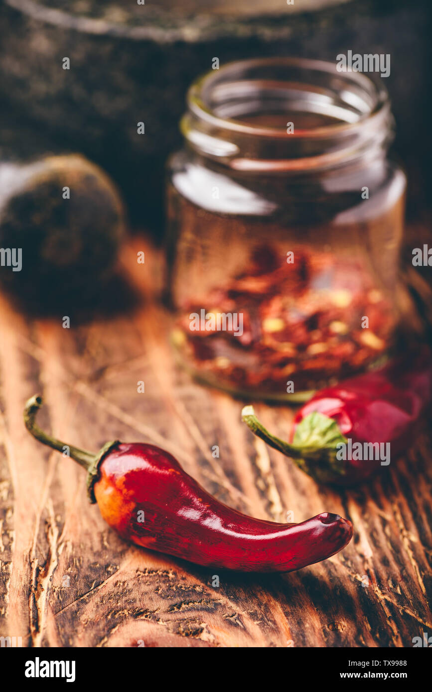 Sun dried red chili peppers on wooden surface Stock Photo - Alamy