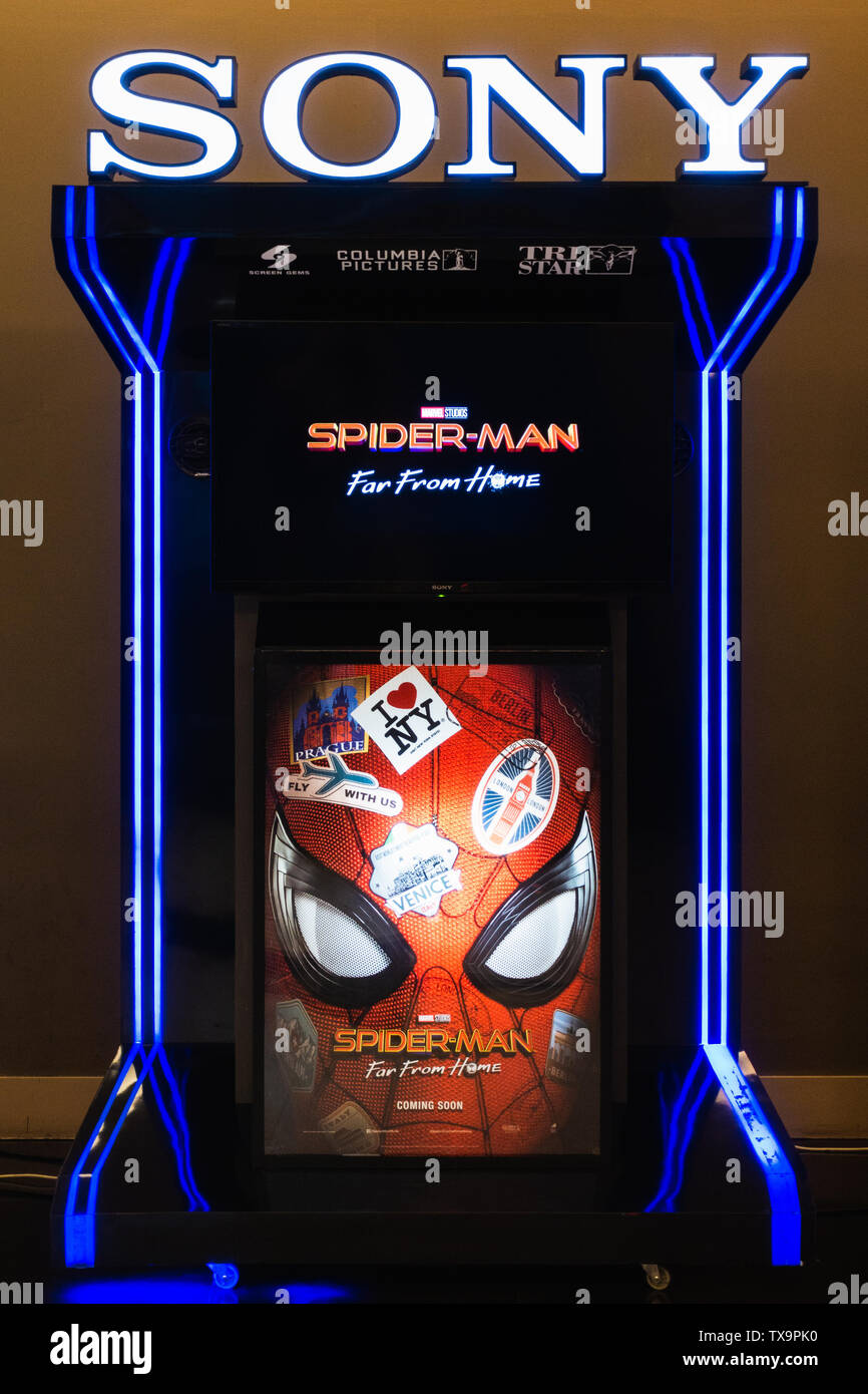 Bangkok, Thailand - Jun 24, 2019: Spider-Man: Far From Home poster and TV screen kiosk display showing movie trailer in theatre. Movie advertisement Stock Photo