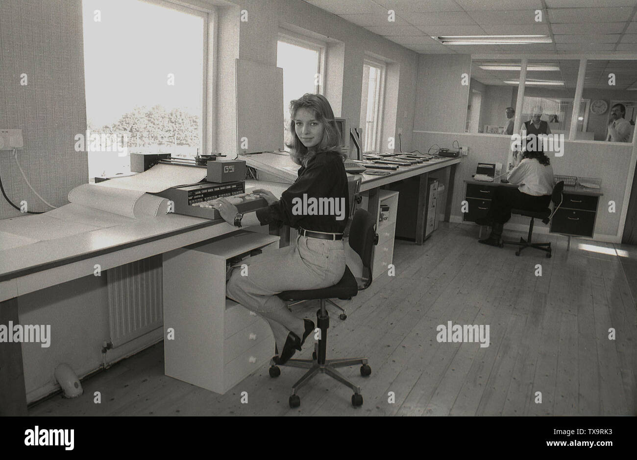 1980s A Young Female In A Bright Design Office With A Wooden