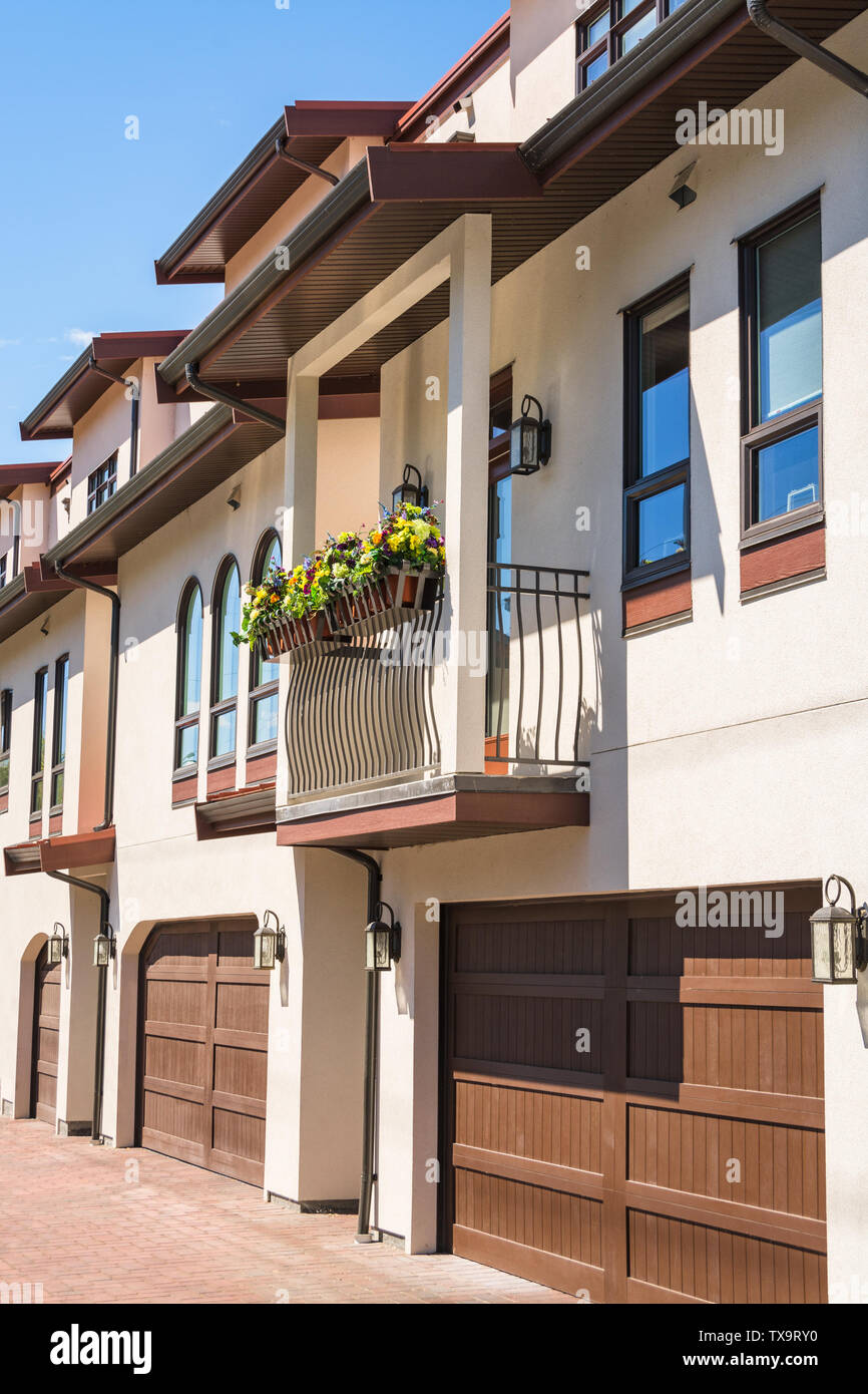 Residential Townhouse With Garages On Ground Level And Flowers On