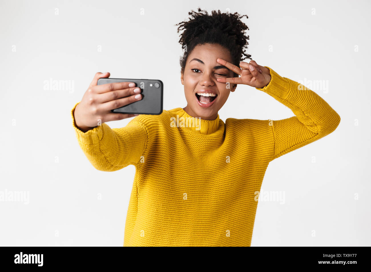 Image closeup of smiling african american woman looking at smartphone ...