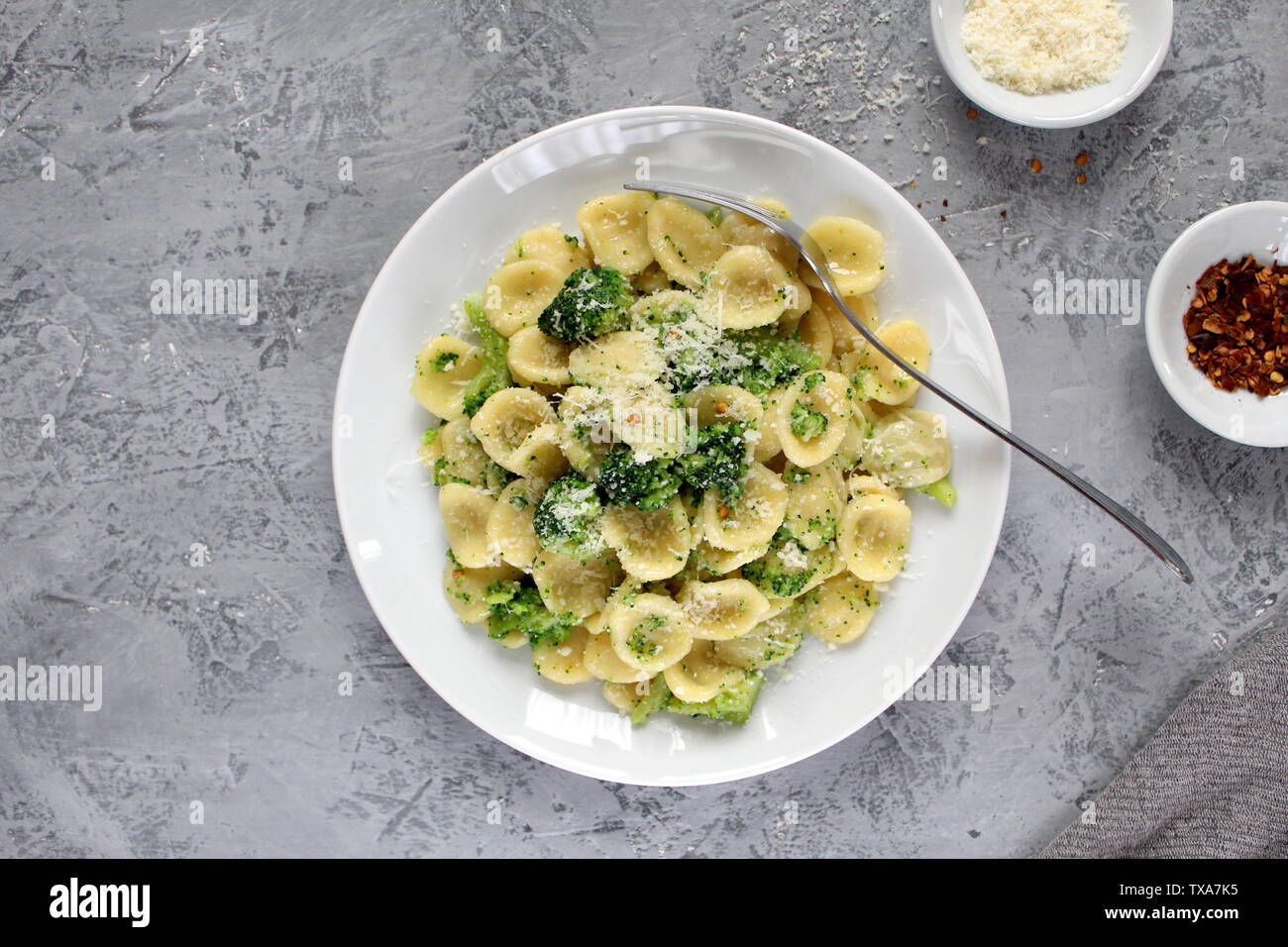 Homemade pasta orecchiette with broccoli, Parmesan cheese and chili