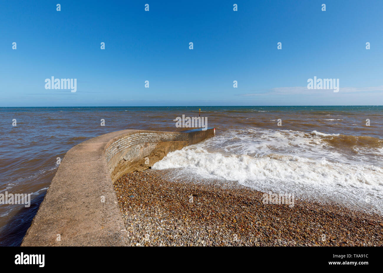 Breakwater on the seashore at Sidmouth with waves, a small popular south coast seaside town in Devon, south-west England Stock Photo