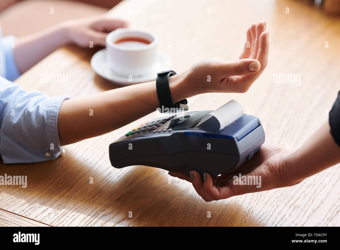 Making contactless payment with smartwatch Stock Photo