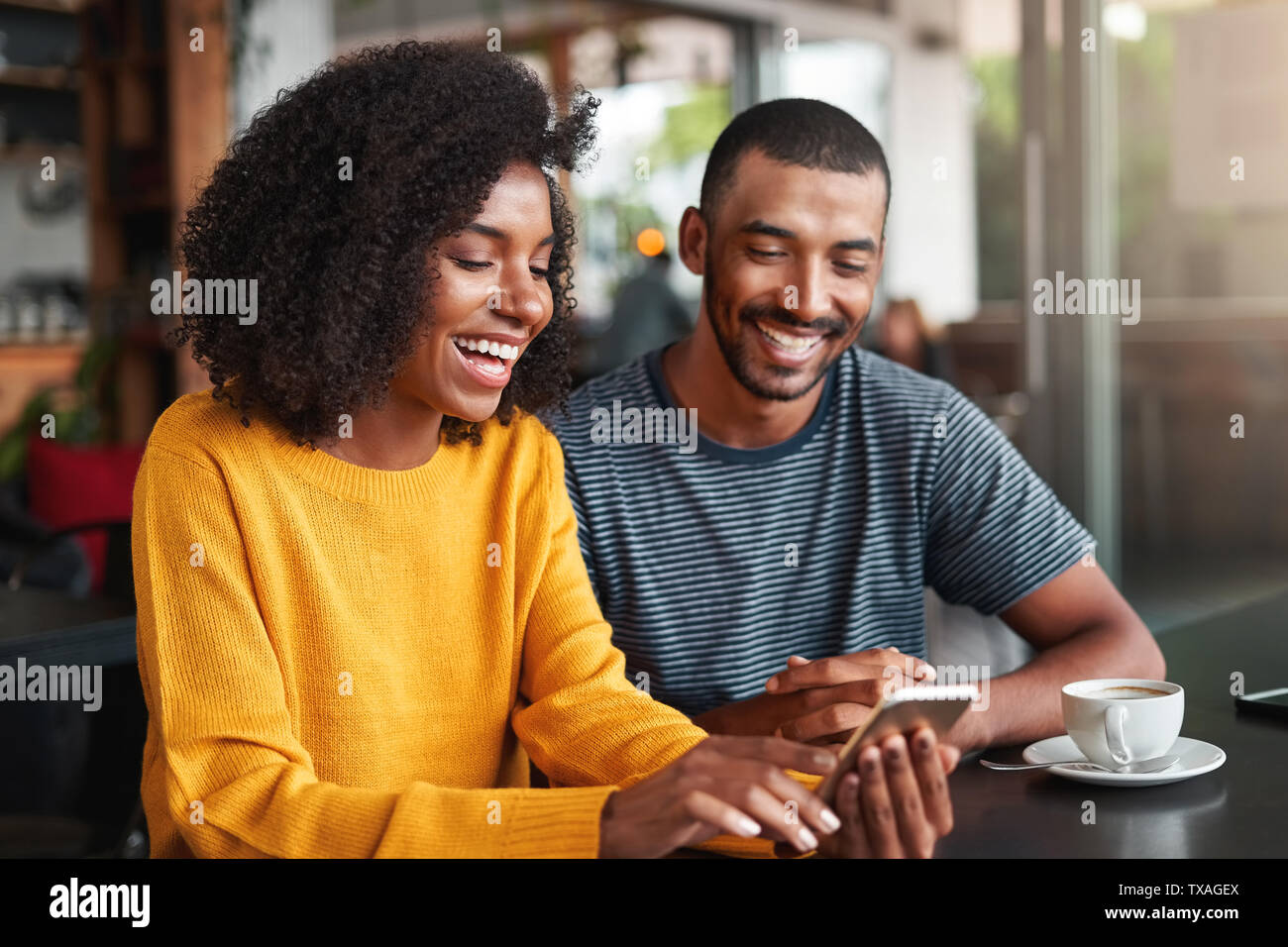 Young couple watching video on mobile phone Stock Photo