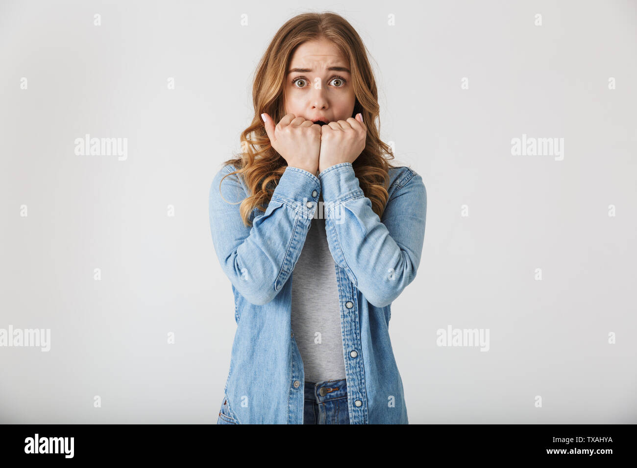 Image of a beautiful scared young pretty woman posing isolated over ...
