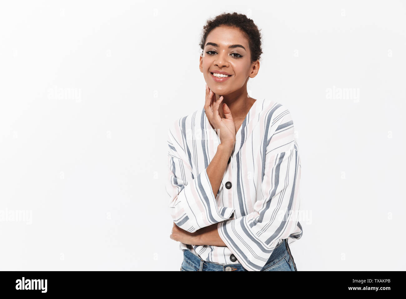 Portrait of an attractive young african woman standing isolated over ...