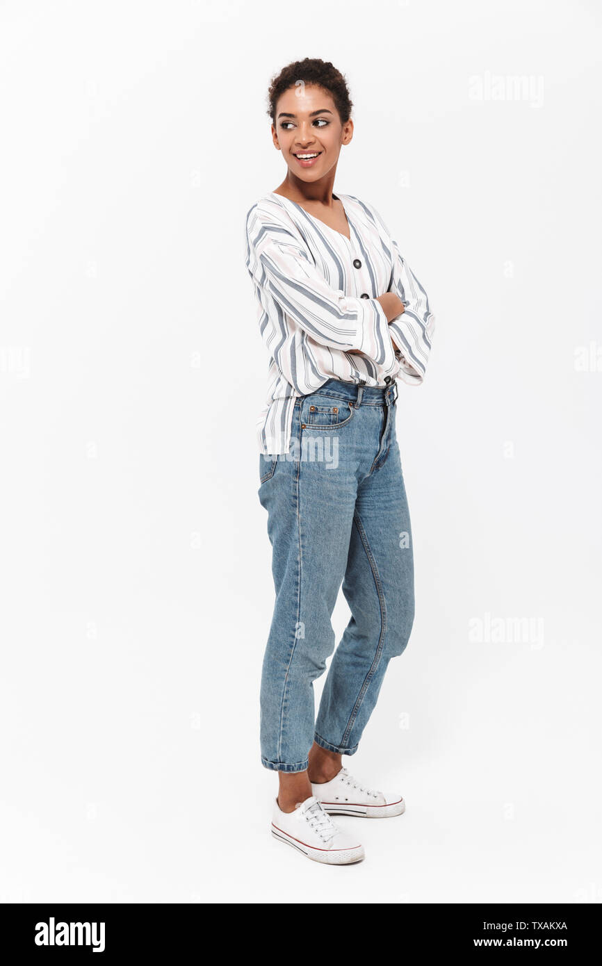 Full length portrait of an attractive young african woman standing ...