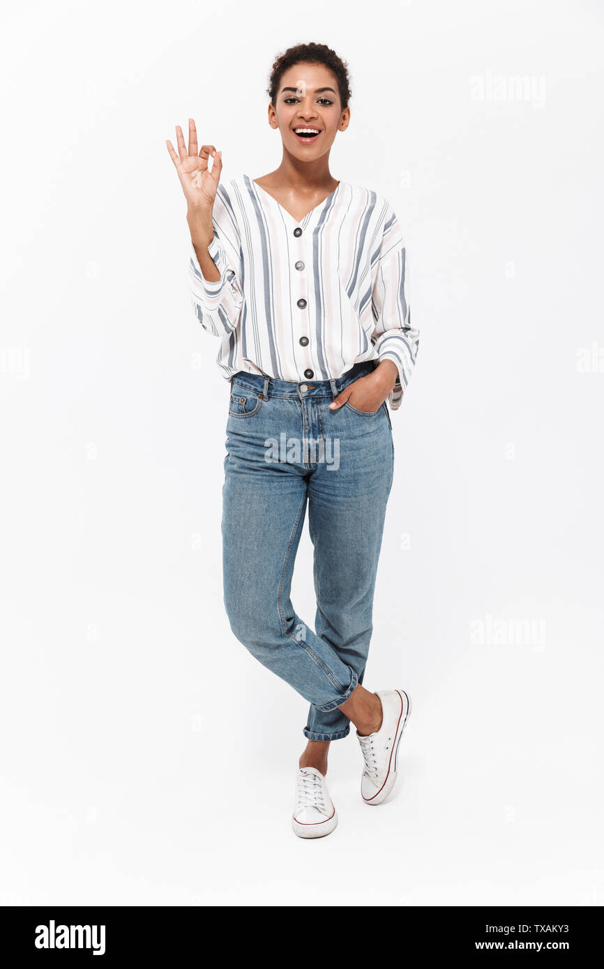 Full length portrait of an attractive young african woman standing ...