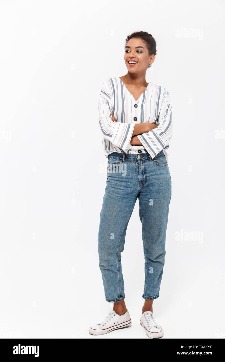 Full length portrait of an attractive young african woman standing ...