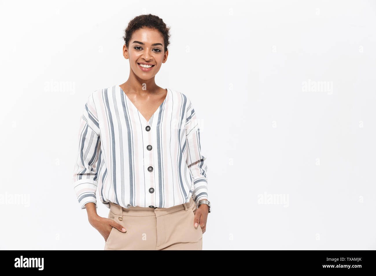 Portrait of a smiling young african businesswoman standing isolated ...