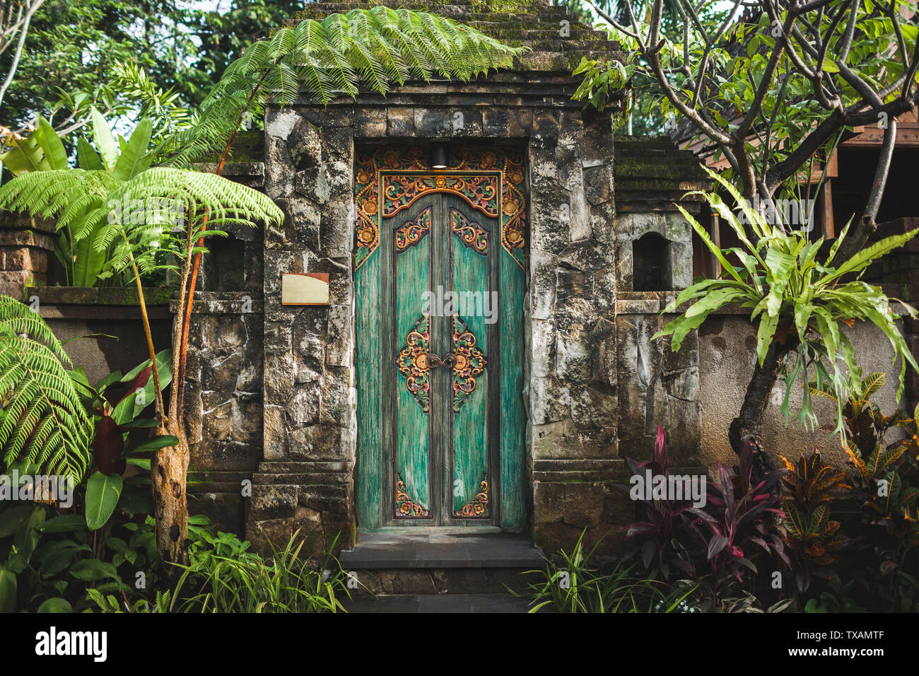 Traditional balinese handmade carved wooden door. Bali style furniture with ornament details Stock Photo