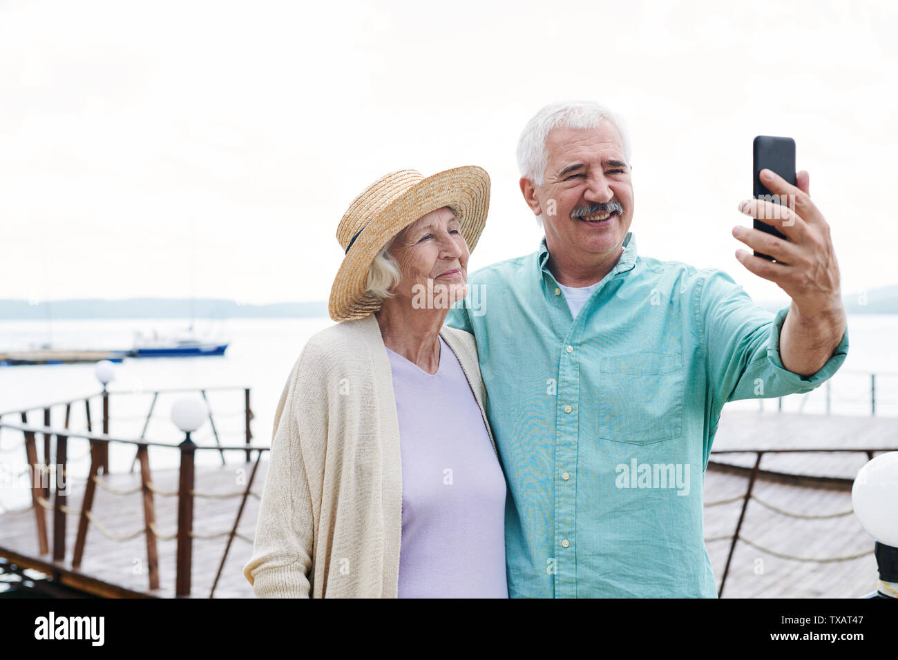 Cheerful senior husband and wife making selfie Stock Photo