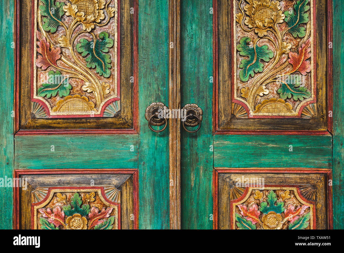 Close-up details of traditional balinese handmade carved wooden door. Bali style furniture with flowers ornament Stock Photo