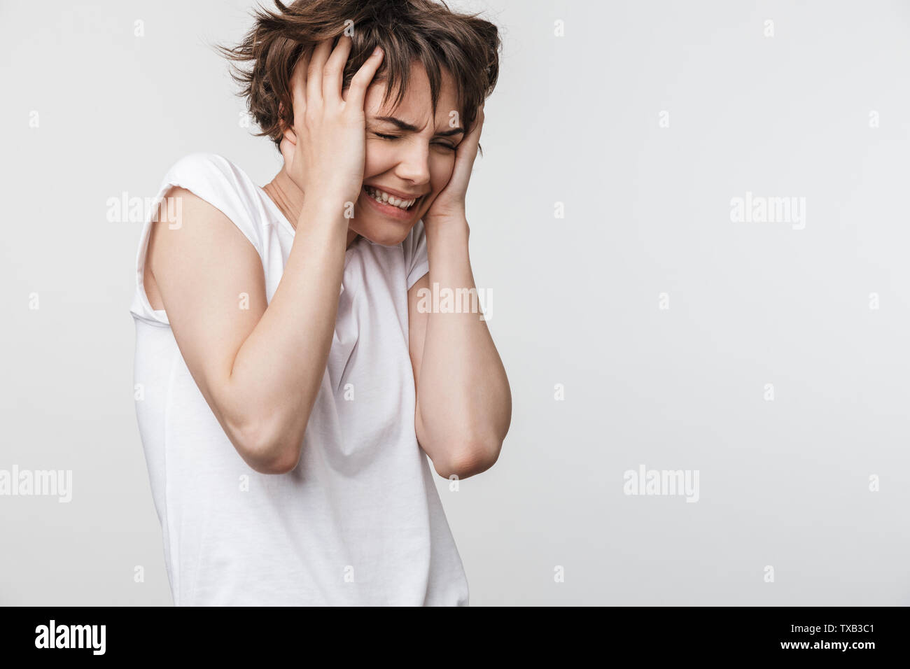 Photo Of Scared Woman With Short Brown Hair In Basic T Shirt