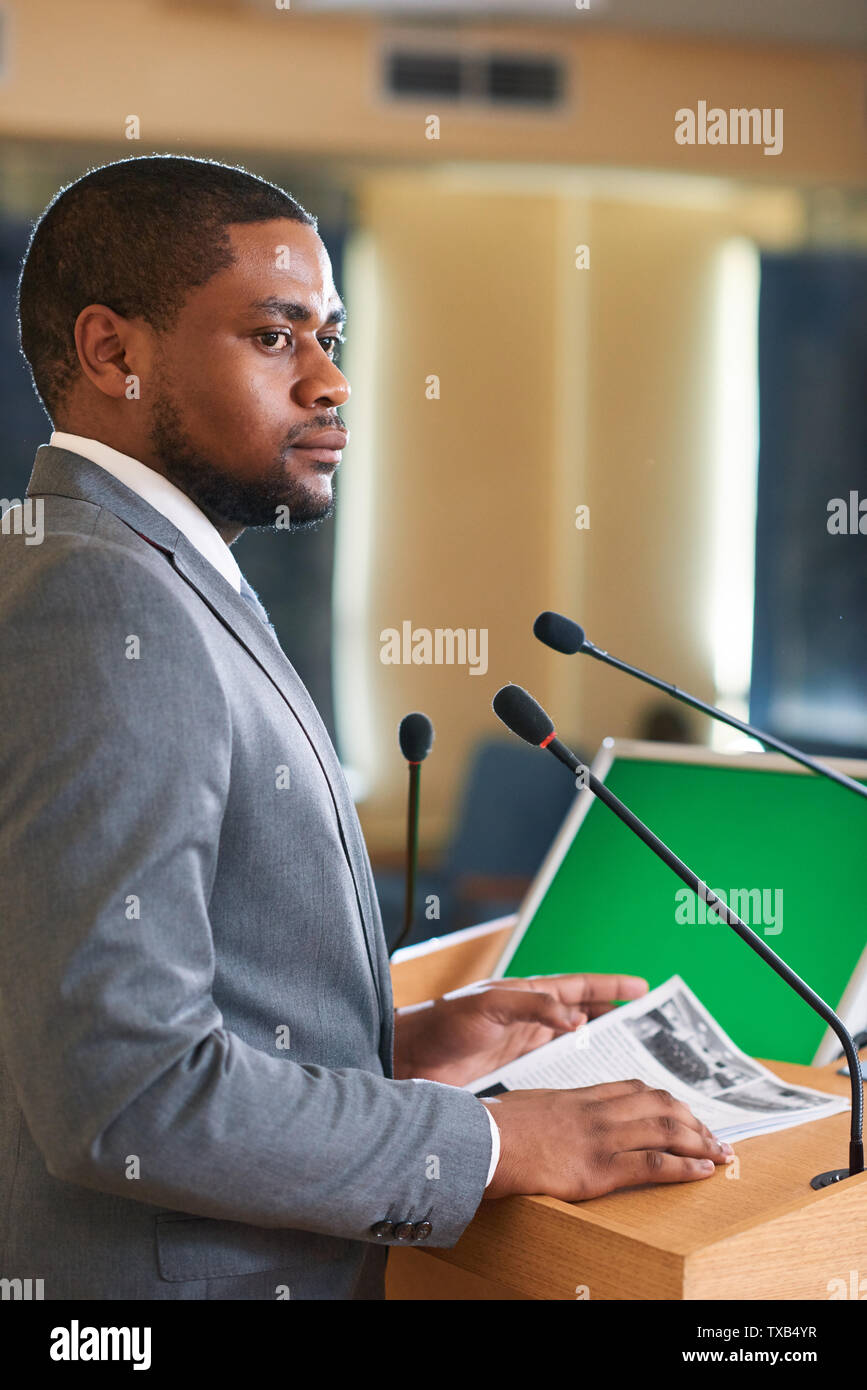 Serious or pensive young elegant delegate with papers Stock Photo