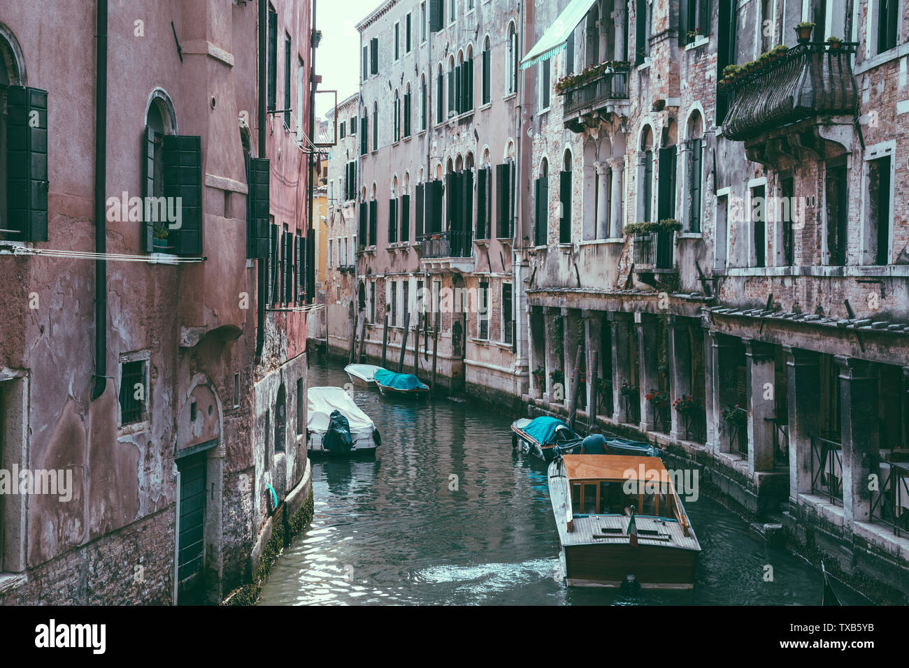 Panoramic view of Venice narrow canal with historical buildings and boat from bridge. Landscape of summer sunny day Stock Photo