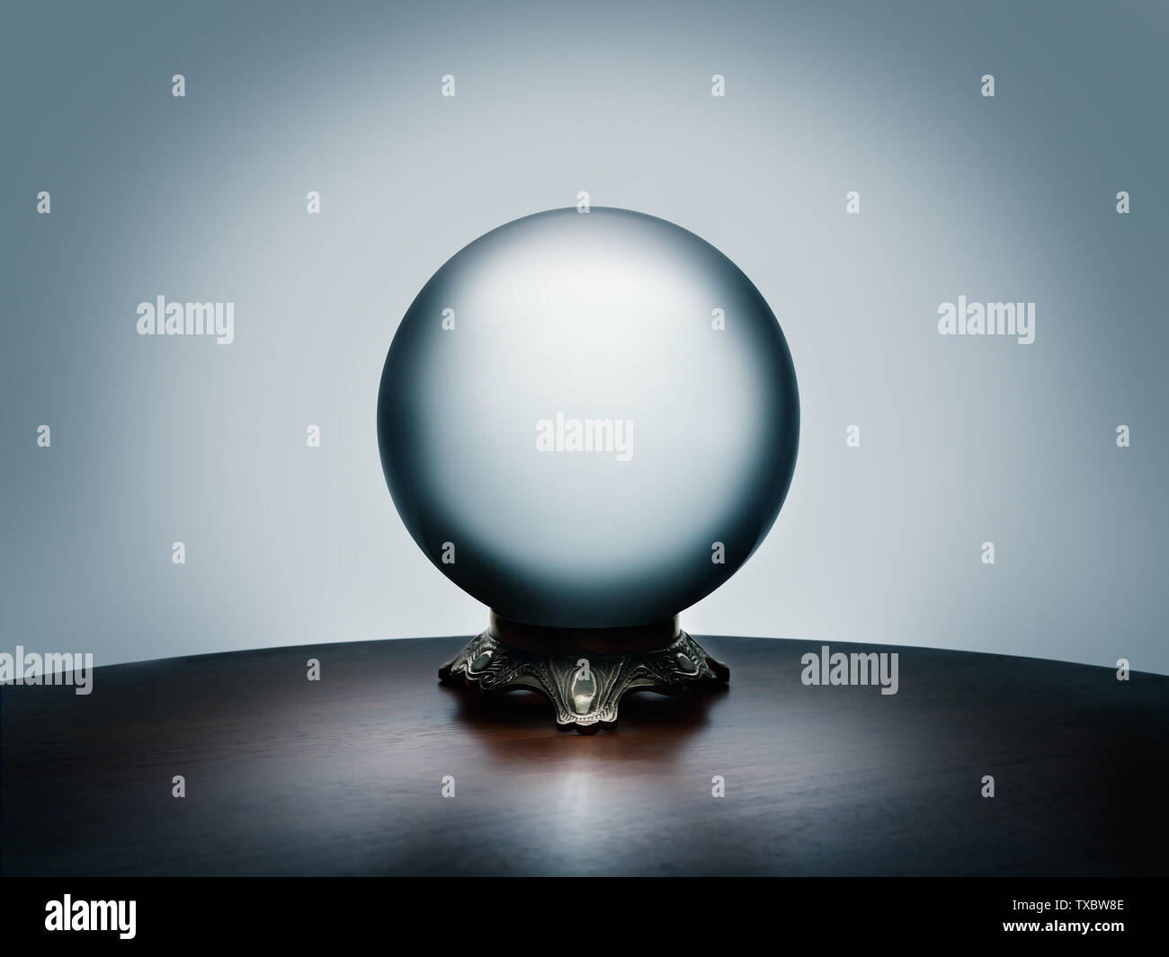 See your future in the magical crystal ball on simple dark wood table Stock Photo