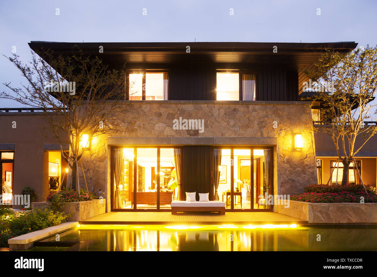 exterior of modern building near pond at night Stock Photo