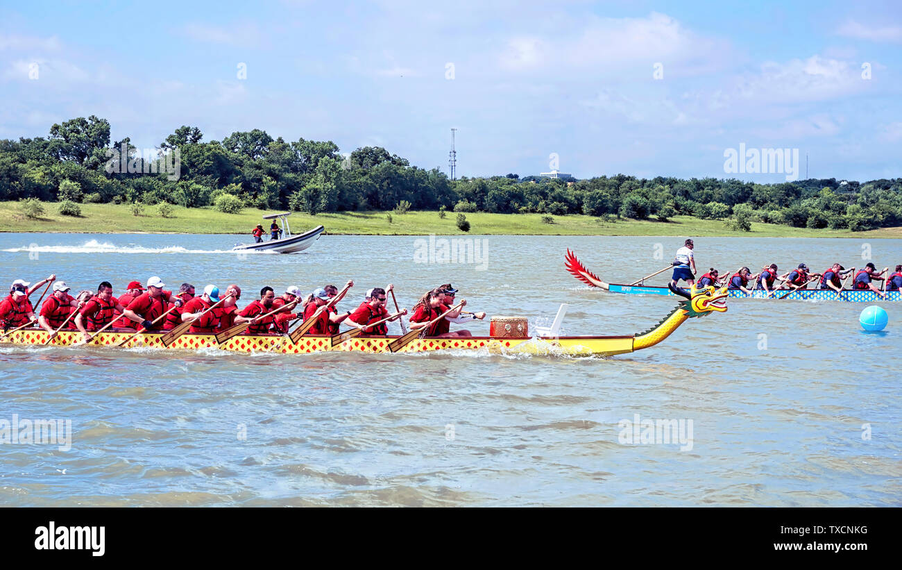 Arlington,Texas - June 15,2019 - Dragon boat race at Lake Viridian. Showing two of the Dragon boats racing at full speed . Stock Photo