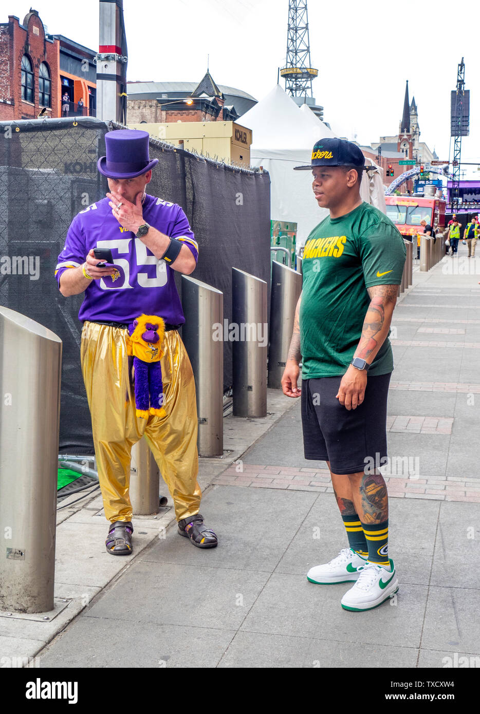 Minnesota Vikings and Green Bay Packers football fans on Broadway at NFL Draft 2019 Nashville Tennessee. Stock Photo