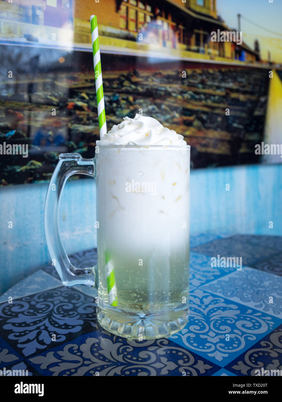 A key lime Italian soda with whipped cream and a paper straw from d'Lish by Tish Cafe in Saskatoon, Saskatchewan, Canada. Stock Photo