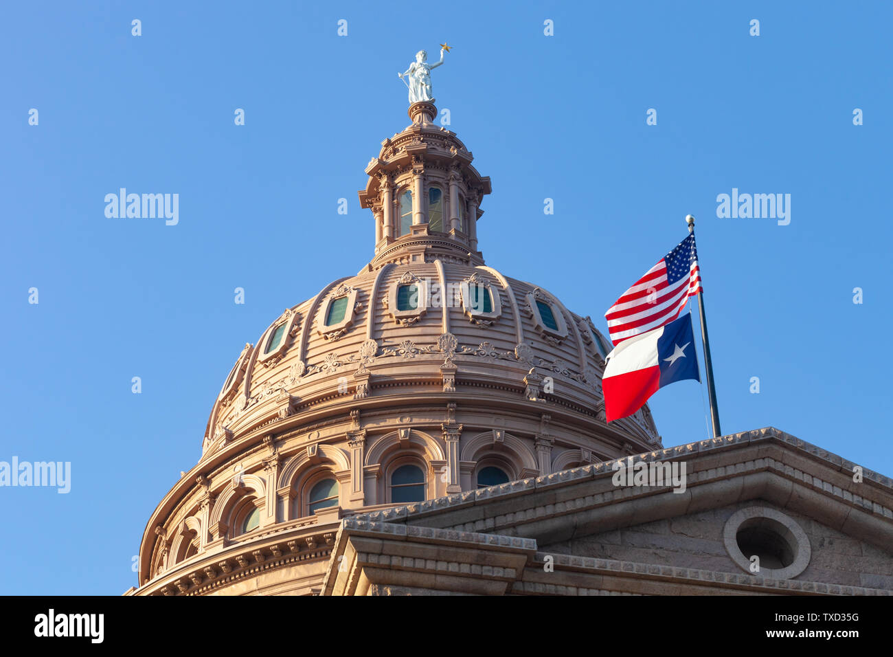 AUSTIN, TEXAS - JUNE 16, 2019 - Dome of Texas State Capitol building in Austin with USA and Texas flags flying on a sunny summer day Stock Photo