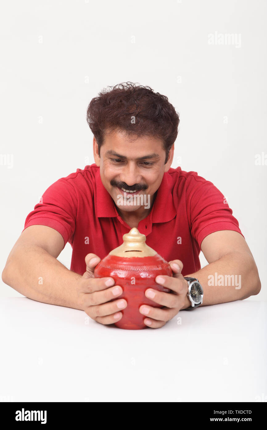 Man with a piggy bank Stock Photo - Alamy
