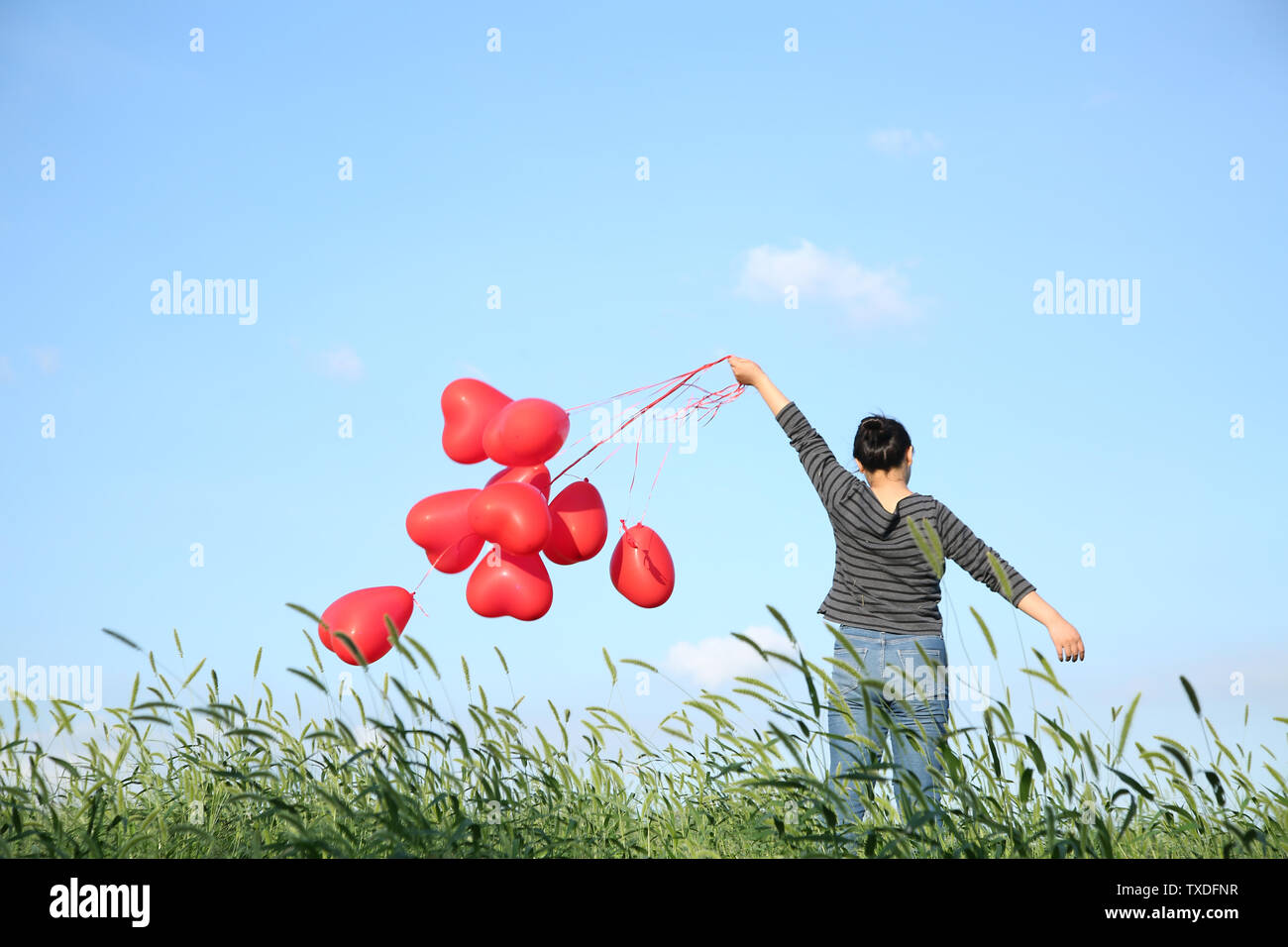 Girl holding red balloon Stock Photo Alamy