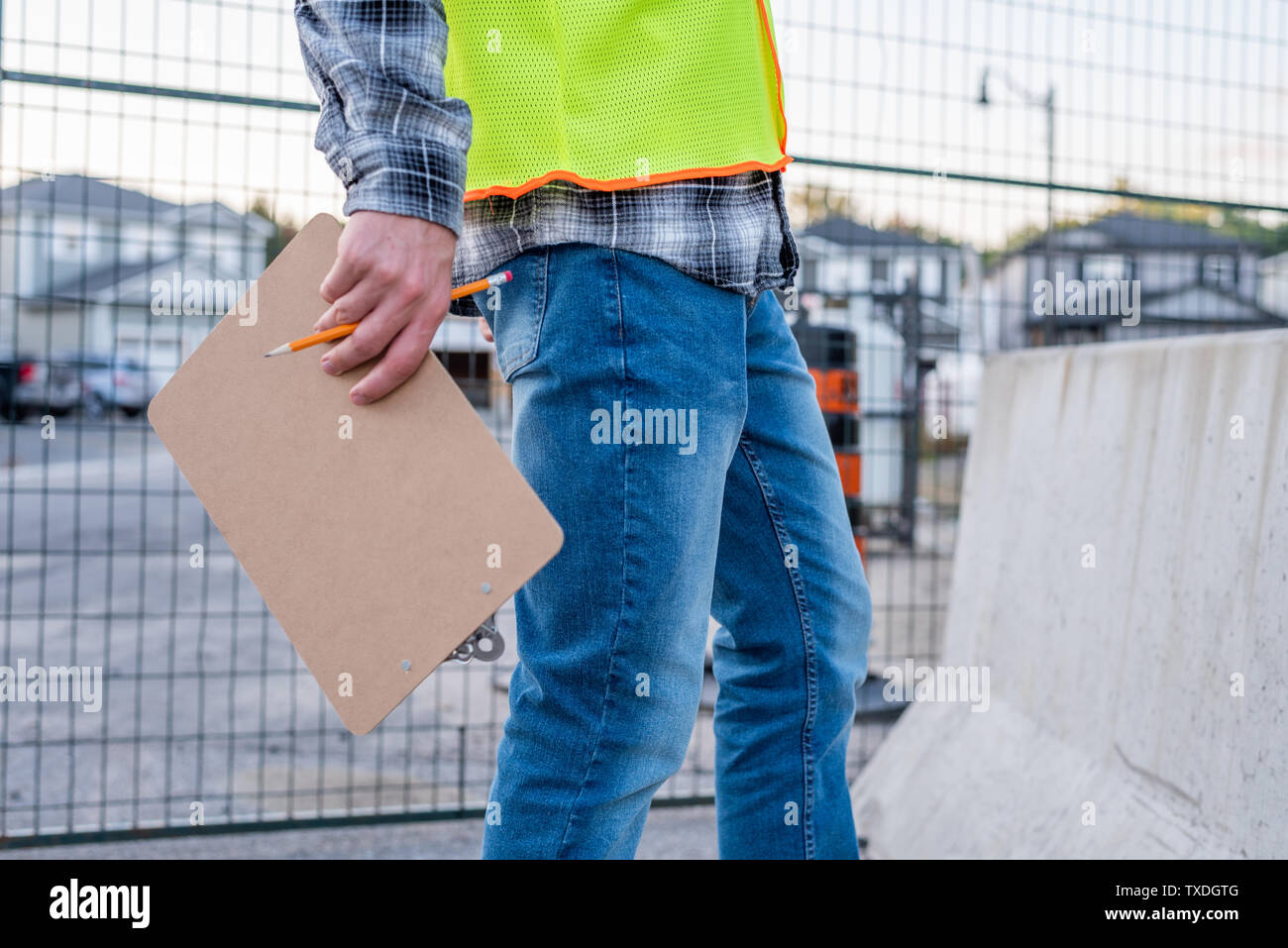 Construction worker holding a clip board close up. Stock Photo