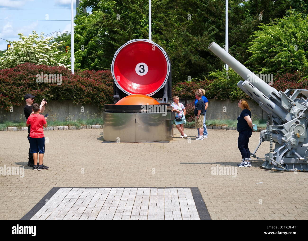 Submarine Force Museum, Groton CT USA, Jun 2019. Tourists taking pictures by deck guns of the past and ballistic missiles in their tubes of today. Stock Photo