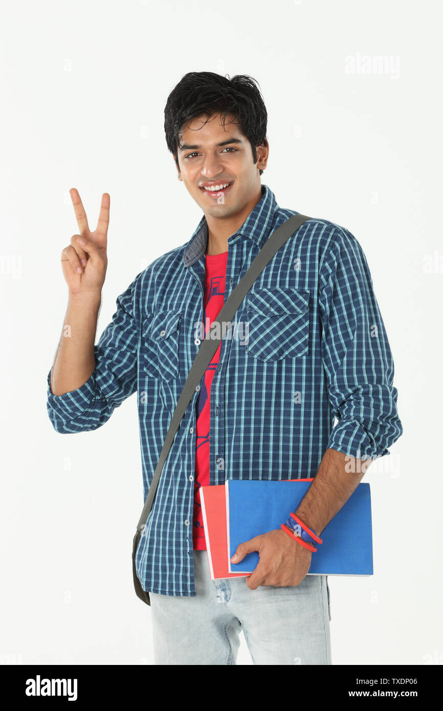 Portrait of a college student showing peace sign Stock Photo - Alamy