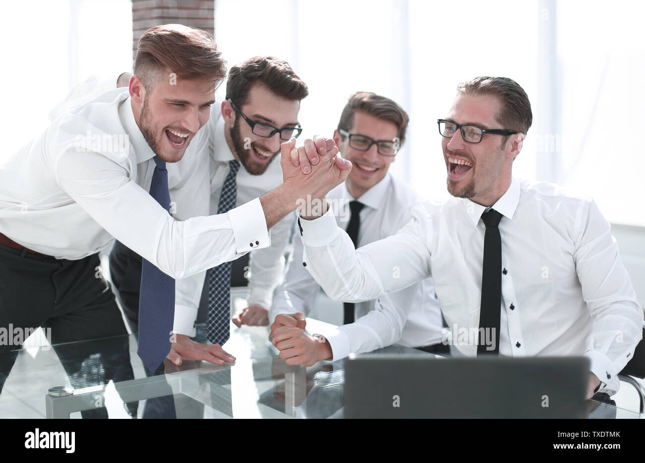 employees giving each other a high five Stock Photo - Alamy