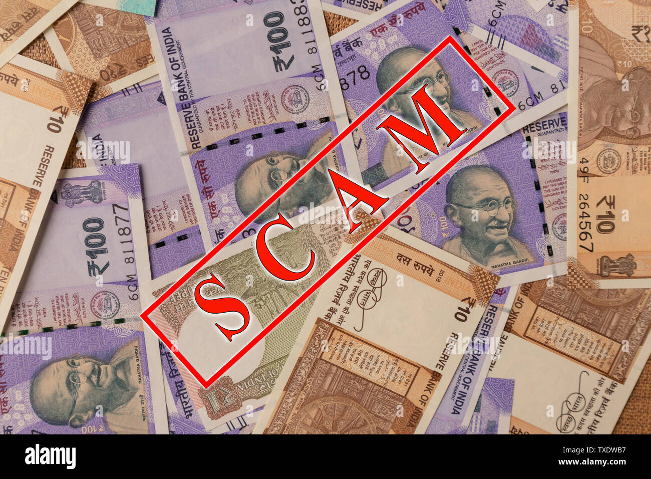Scam and money concept, Scam in red alphabets printed on Indian currency Notes Stock Photo