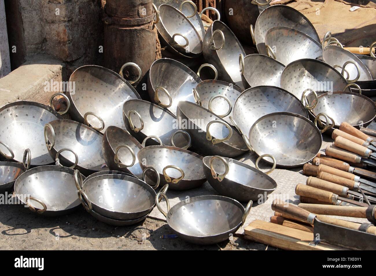 Close Up Of A Pile Of Indian Kadai Cooking Pans TXE0Y1 