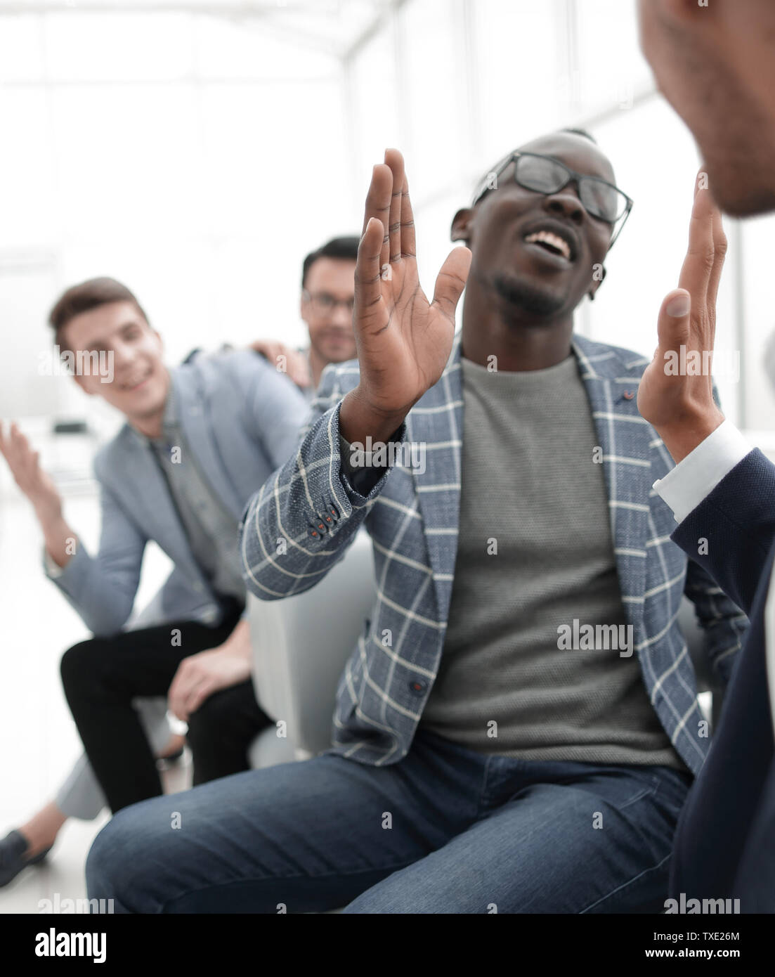 happy employees giving each other a high five Stock Photo - Alamy