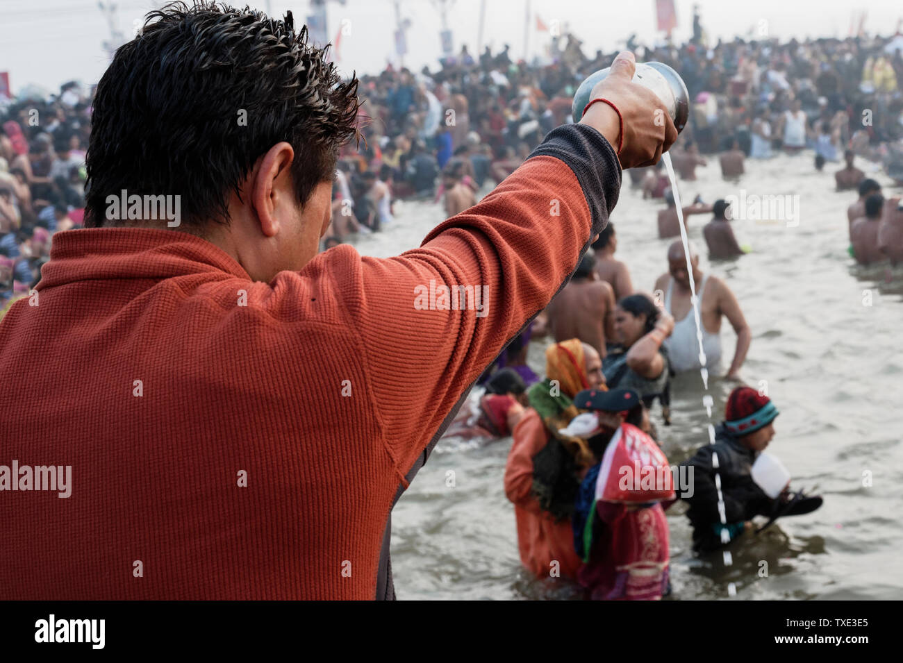 Pouring water into the Ganges river and Ritual bathing, Allahabad Kumbh