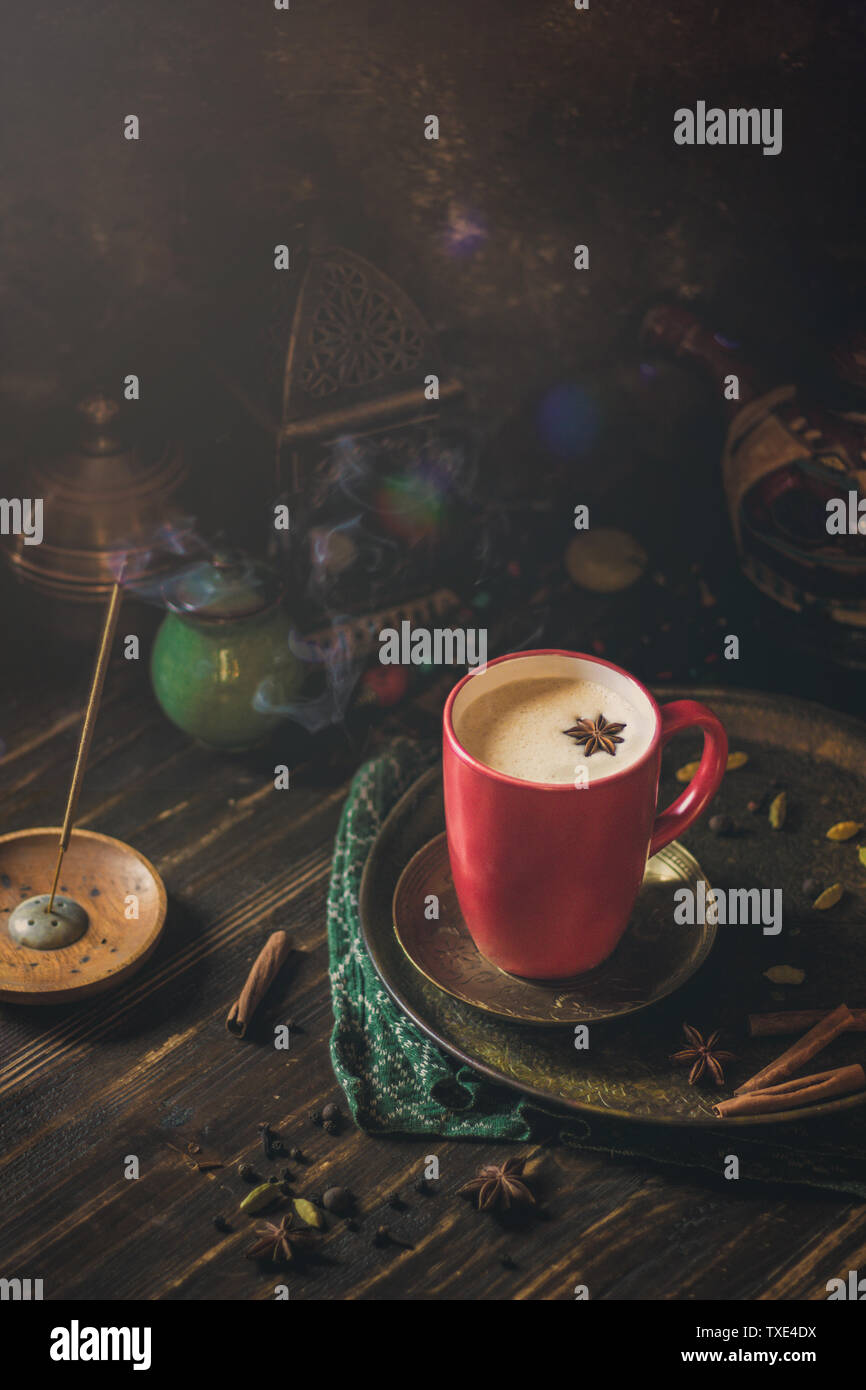 Masala chai, red cup, spice tea, east mood, indian tea, darck background Stock Photo